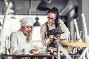 Restaurant owner consults with chef
